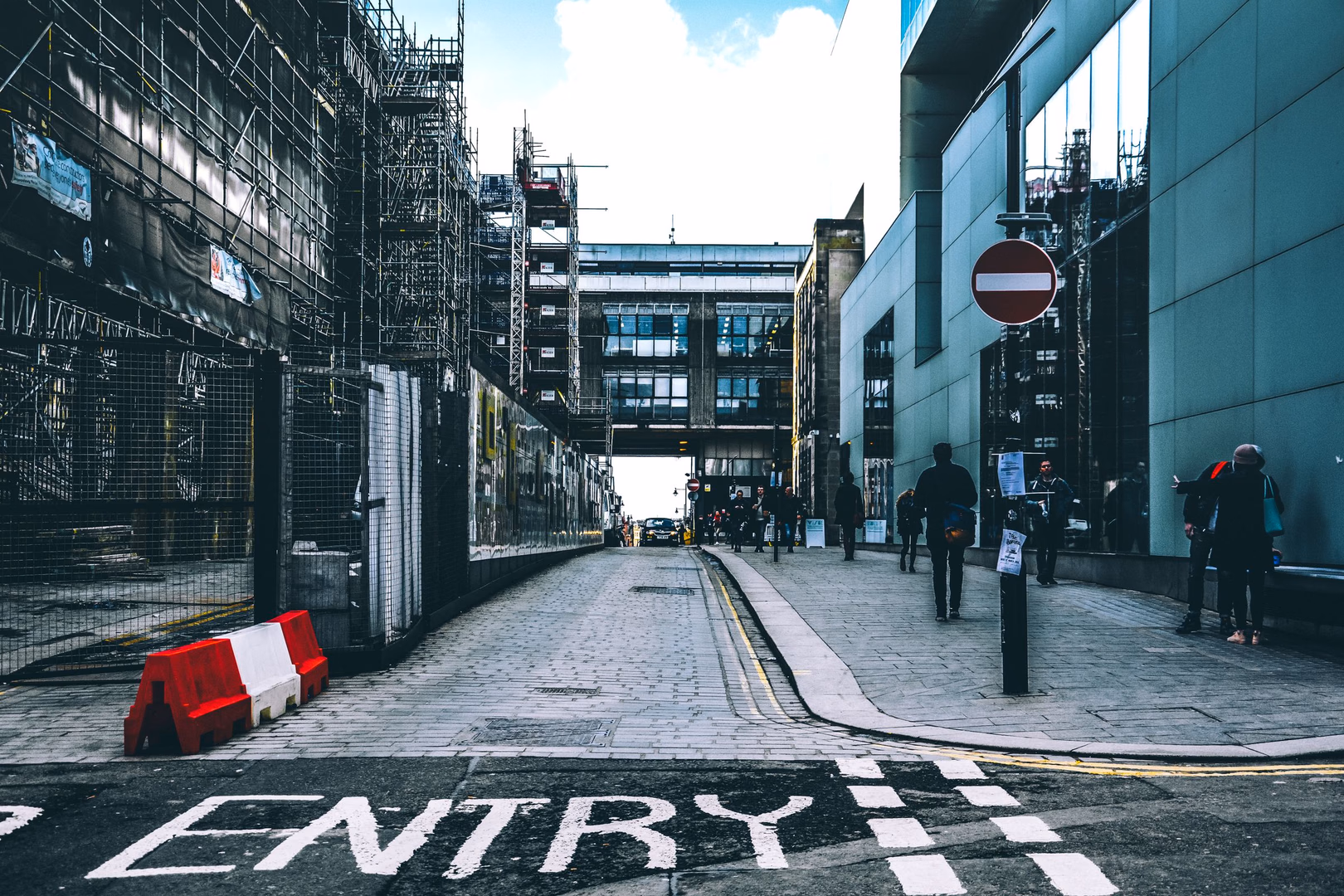 A city street lined with buildings and scaffolding.